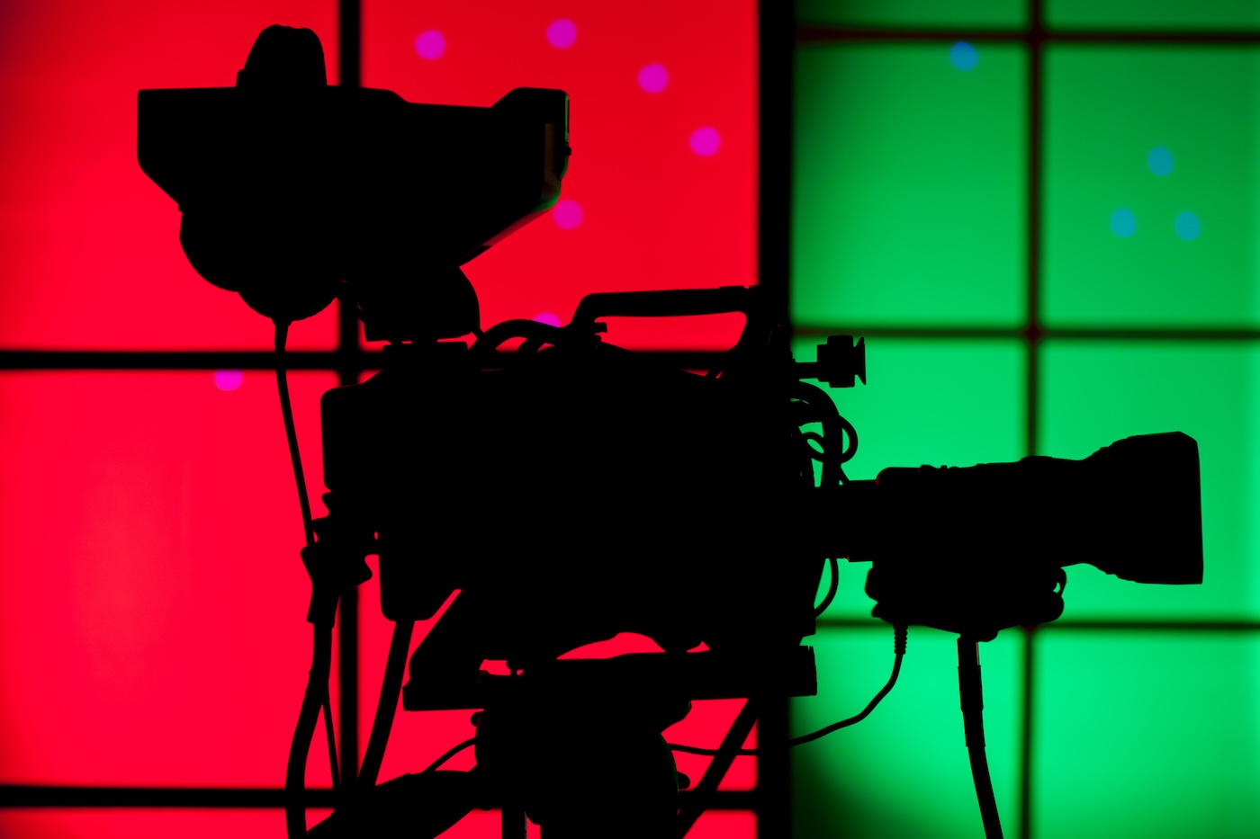A professional TV camera with red and green background